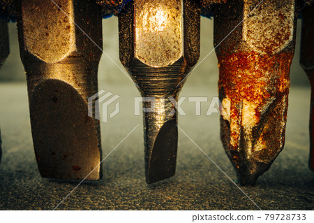 Metal screwdriver bits on concrete background macro Metal screwdriver bits on concrete background macro 79728733