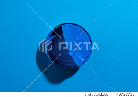 Blue tin can on blue background close up 79728735