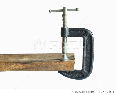 Metal Clamp tool on Wood on background. 79729103