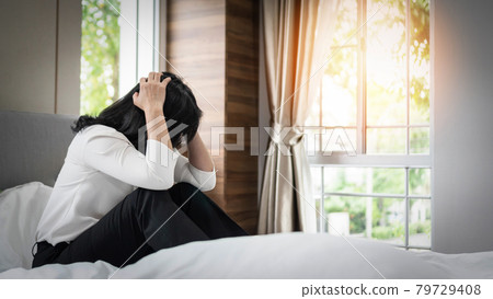 Panic attack business woman, stressful depressed emotional jobless businesswoman with anxiety disorder mental health illness, headache and migraine sitting on bed at home Panic attack business woman, stressful depressed emotional jobless businesswoman with anxiety disorder mental health illness, headache and migraine sitting on bed at home 79729408