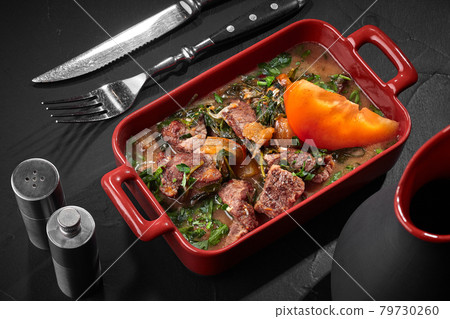 Georgian stew Chakapuli of veal with tarragon and persimmon Georgian stew Chakapuli of veal with tarragon and persimmon 79730260