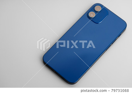 Blue modern smartphone with double-lens camera on gray background 79731088