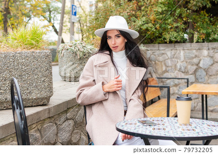 Portrait of a woman at cafe table Portrait of a woman at cafe table 79732205