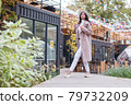 beautiful woman in the autumn park 79732209