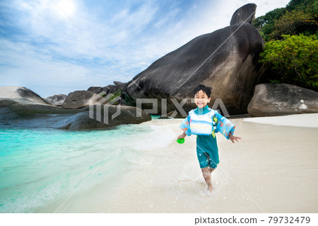 Asian boy fun and runing on the beach in Similan island Asian boy fun and runing on the beach in Similan island 79732479
