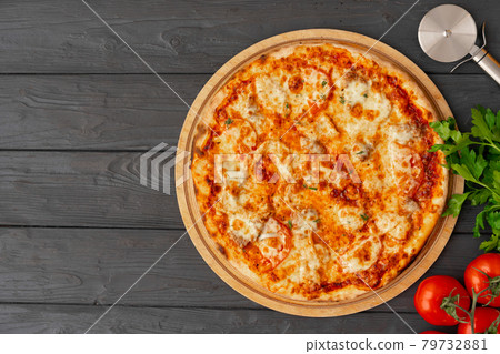 Tasty pizza on black wooden background top view 79732881
