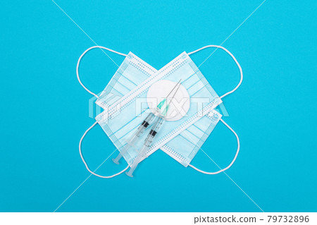 Vaccination or Revaccination Concept - Two Medical Syringe on Blue Table Vaccination or Revaccination Concept - Two Medical Syringe on Blue Table 79732896