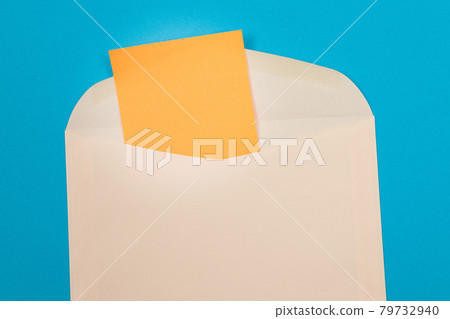Beige Envelope with Blank Orange Sheet of Paper Inside Beige Envelope with Blank Orange Sheet of Paper Inside 79732940