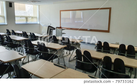 An empty classroom filled with silence An empty classroom filled with silence 79733162