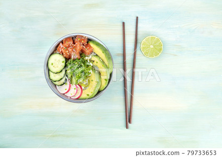 Hawaii tuna poke salad with lime, chopsticks, and copy space 79733653