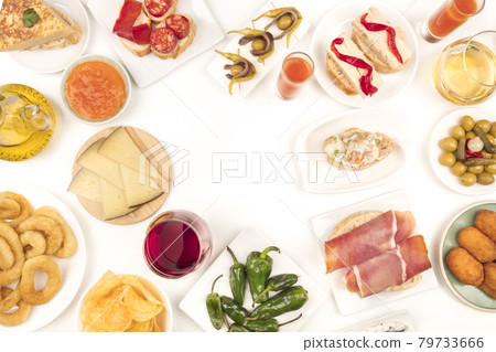 An overhead photo of Spanish tapas, forming frame on white with place for text 79733666