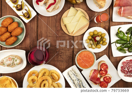 The food of Spain. Overhead photo of many different Spanish tapas with wine and copy space The food of Spain. Overhead photo of many different Spanish tapas with wine and copy space 79733669