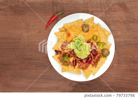 Nachos with cheese and chilli, traditional Mexican snack, with copyspace Nachos with cheese and chilli, traditional Mexican snack, with copyspace 79733798