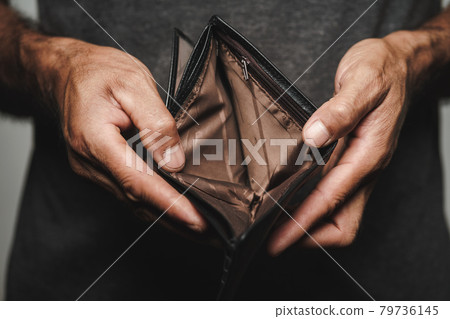 Close up of man hands holding and empty wallet. financial crisis, bankruptcy, no money, bad economy Concept. 79736145