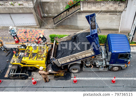 Asphalt paved road repair work 79736515