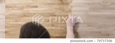 Man treats wooden surface of table with a protective varnish 79737506