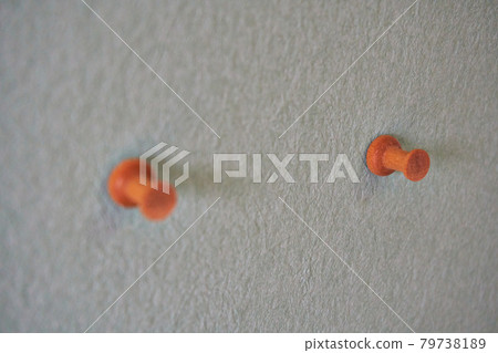 A thumbtack stuck in the wall A thumbtack stuck in the wall 79738189