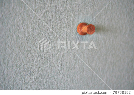 A thumbtack stuck in the wall A thumbtack stuck in the wall 79738192