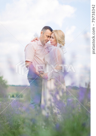 Happy middle aged couple, embracing and enjoying romantic moments together in the lavender field 79738342