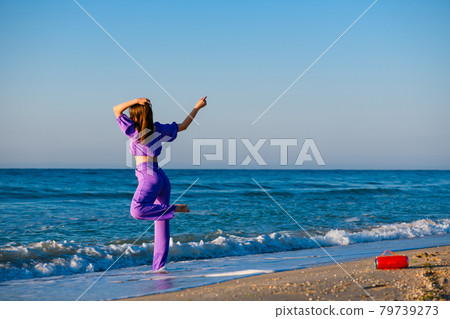 Girl dance at beach with bluetooth speaker Girl dance at beach with bluetooth speaker 79739273