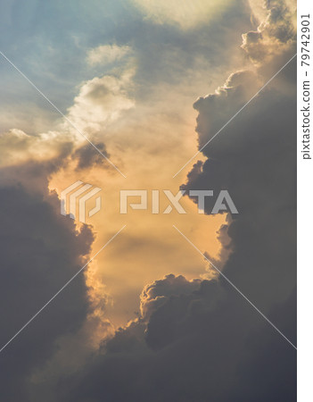 The sun shines through the clouds in the sky. The shape of the clouds evokes imagination and creativity. They can be used as wallpapers that look amazing. The sun shines through the clouds in the sky. The shape of the clouds evokes imagination and creativity. They can be used as wallpapers that look amazing. 79742901