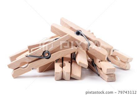 A pile of wooden clothespins on a white background. Isolated 79743112
