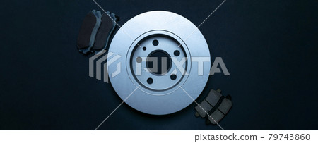 Car service. Auto motor mechanic spare or automotive piece on dark background. New metal car part. Repair and vehicle service with space for text. Car service. Auto motor mechanic spare or automotive piece on dark background. New metal car part. Repair and vehicle service with space for text. 79743860