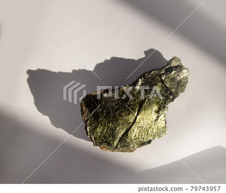 Shiny green muscovite mica mineral sheet on white background. Found in Miass, Ural, Russia. For geology mineralogy magazines websites article, Natural Science museum wall chart Shiny green muscovite mica mineral sheet on white background. Found in Miass, Ural, Russia. For geology mineralogy magazines websites article, Natural Science museum wall chart 79743957