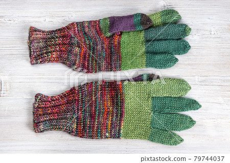 back side of hand knitted woolen gloves on table back side of hand knitted woolen gloves on table 79744037