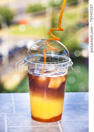 Bumble coffee - refreshment summer iced cocktail with espresso, orange juice, caramel syrup and ice 79745587