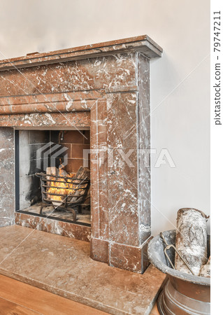 Stylish fireplace in a spacious living room Stylish fireplace in a spacious living room 79747211