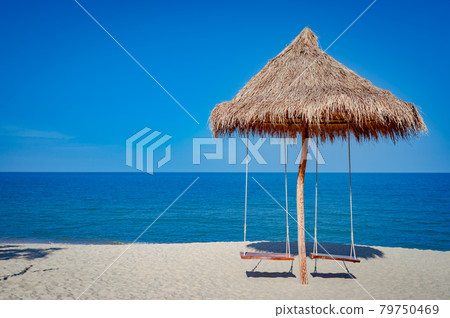 Swing under a wooden hut by the beach 79750469