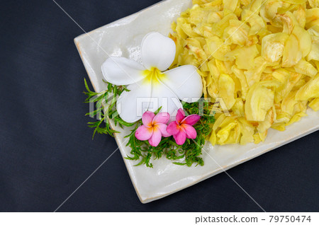 Fried durian with flowers and leaves in dish on table Fried durian with flowers and leaves in dish on table 79750474