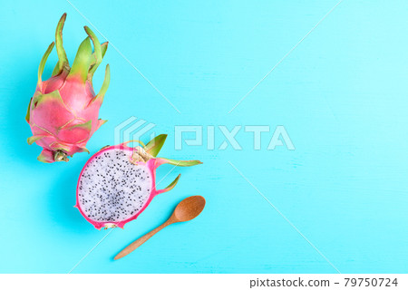 Half dragon fruit or pitaya and wooden spoon for eating on color background Half dragon fruit or pitaya and wooden spoon for eating on color background 79750724