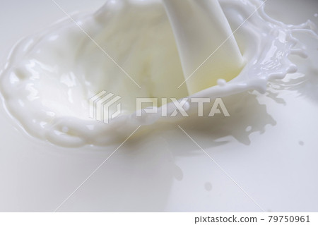 Pour milk close-up 79750961