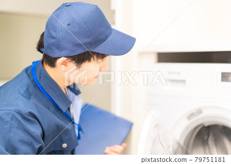 A man in work clothes inspecting a house 79751181