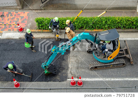 Asphalt paved road repair work 79751728