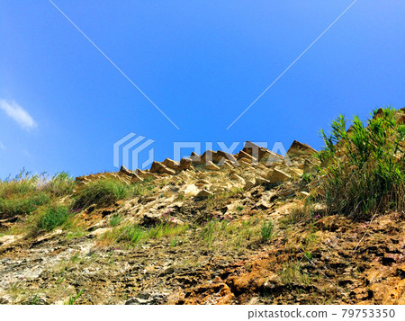 Background with mountain or hill with rocks and blue sky 79753350