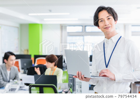 A businessman using a laptop in the office A businessman using a laptop in the office 79754434