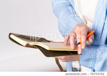 Leather notebook with pencil in hand 79754792