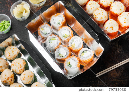 Sushi roll delivery, on old dark rustic background Sushi roll delivery, on old dark rustic background 79755088
