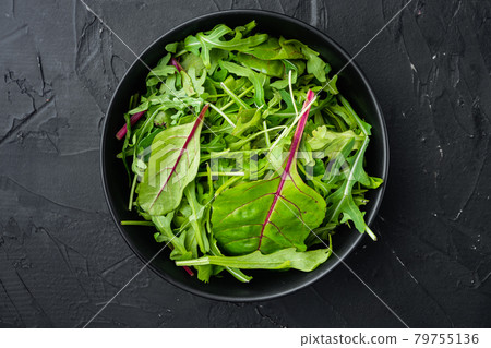 Mix Salad leafs, Swiss chard and Arugula, on black stone background, top view flat lay, with copy space for text 79755136