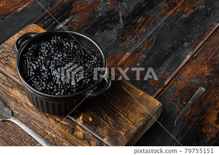 Bowl of black caviar, on old dark wooden table background Bowl of black caviar, on old dark wooden table background 79755151