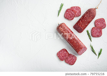 Salami with herbs and spices, on white stone table background, top view flat lay, with copy space for text Salami with herbs and spices, on white stone table background, top view flat lay, with copy space for text 79755216