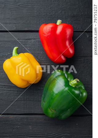 Green , yellow and red bell pepper, on black wooden table background, top view flat lay 79755217