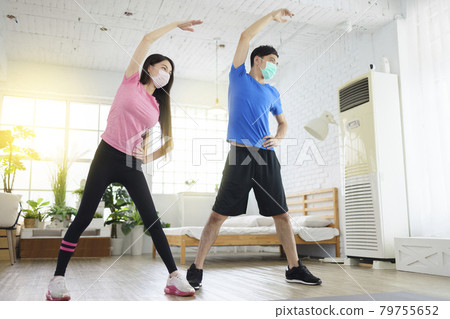 Young couple wear with medical masks exercising. 79755652
