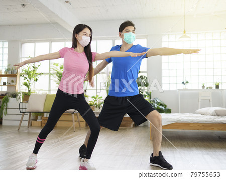 Young couple wear with medical masks exercising  79755653