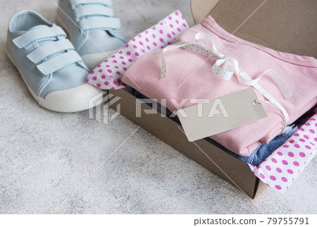 Clothes fir kids in an open cardboard box Clothes fir kids in an open cardboard box 79755791