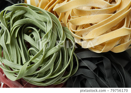 Different uncooked multicolor pasta on whole background 79756170