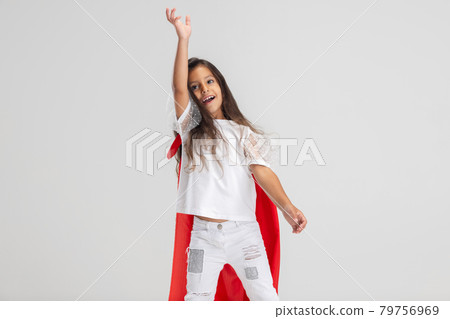 Half-length portrait of one cute Caucasian preschool girl in red cape isolated over white studio background. Half-length portrait of one cute Caucasian preschool girl in red cape isolated over white studio background. 79756969